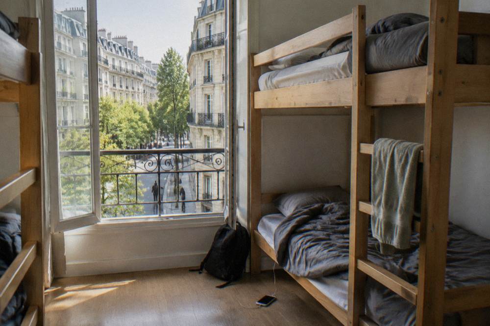 Bunk beds in a bright Paris hostel dormitory room
