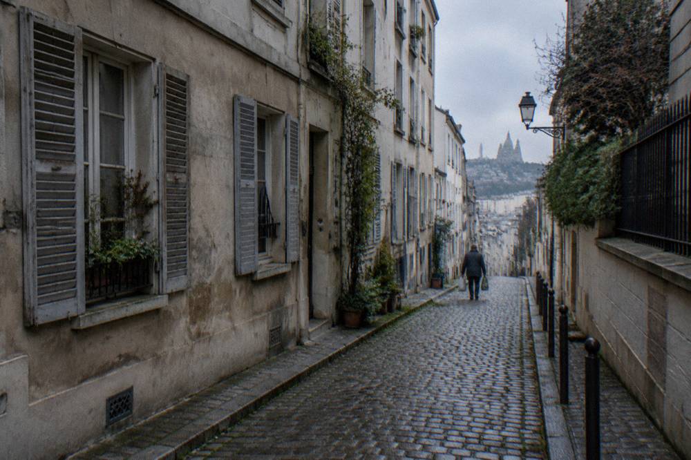 A narrow Paris lane with shuttered windows and a bicycle leaning against a wall