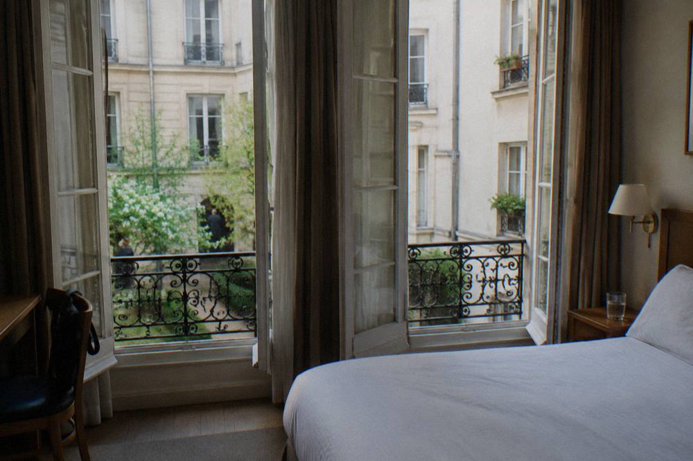 A simple hotel double room with a window onto a Paris courtyard