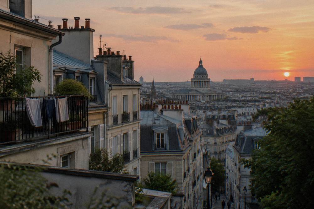 Evening view over Paris rooftops with the Pantheon dome in the distance