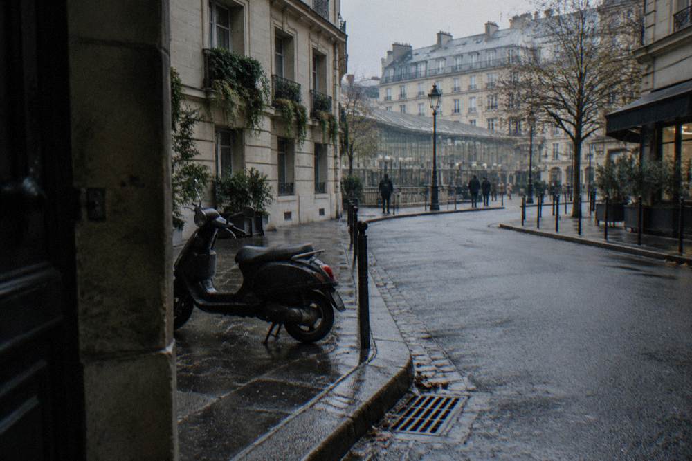 A quiet Parisian side street in late afternoon light with parked bicycles