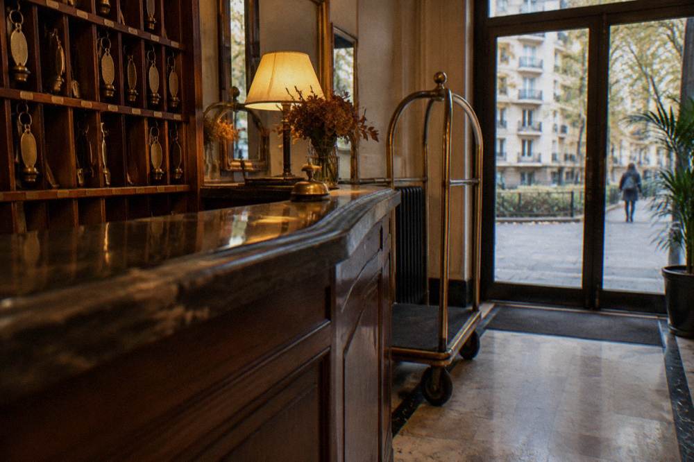 A reception desk with a room key rack behind it