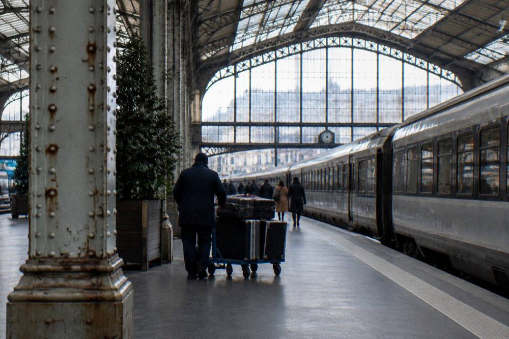 Train platform under a glass and iron station roof in Paris