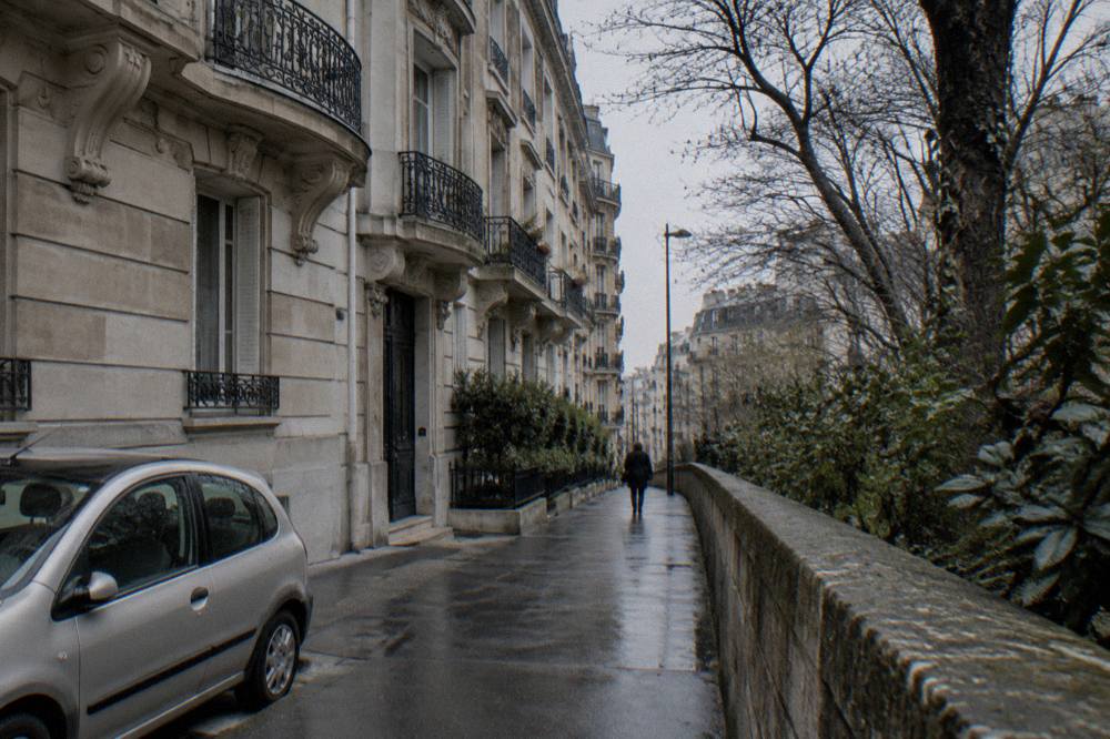 An elegant residential street in the seventh arrondissement with stone facades and wrought-iron balconies
