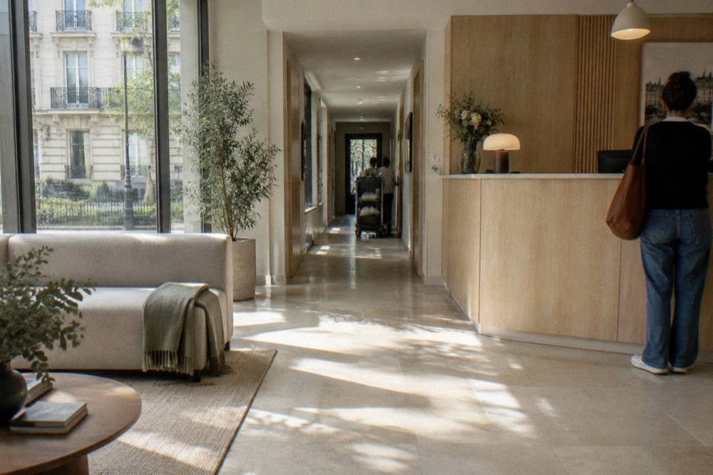 A modern aparthotel lobby with a reception desk and seating area