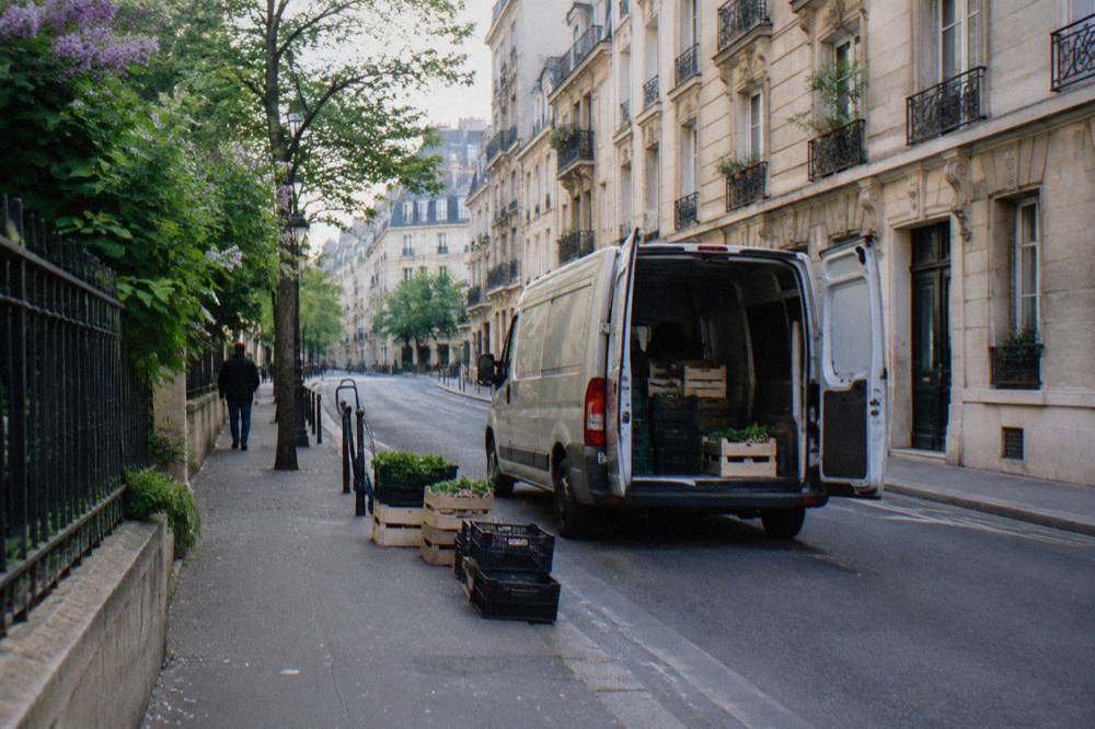 A narrow Paris street in the morning with Haussmann-style facades and parked bicycles