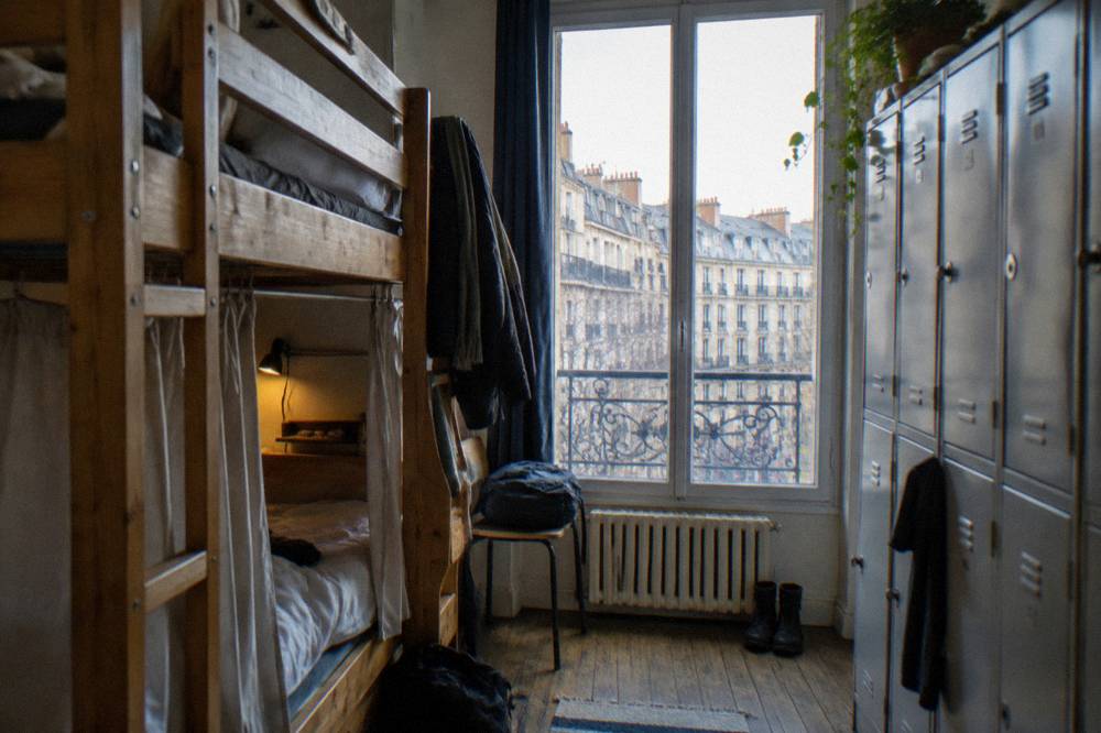Bunk beds with personal reading lights and storage lockers in a shared dormitory room