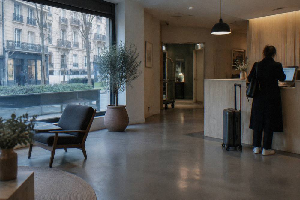 A reception desk in a small modern hotel lobby in Paris