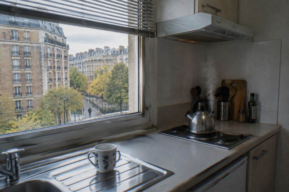A small kitchenette with a kettle and hob in a Paris apartment hotel
