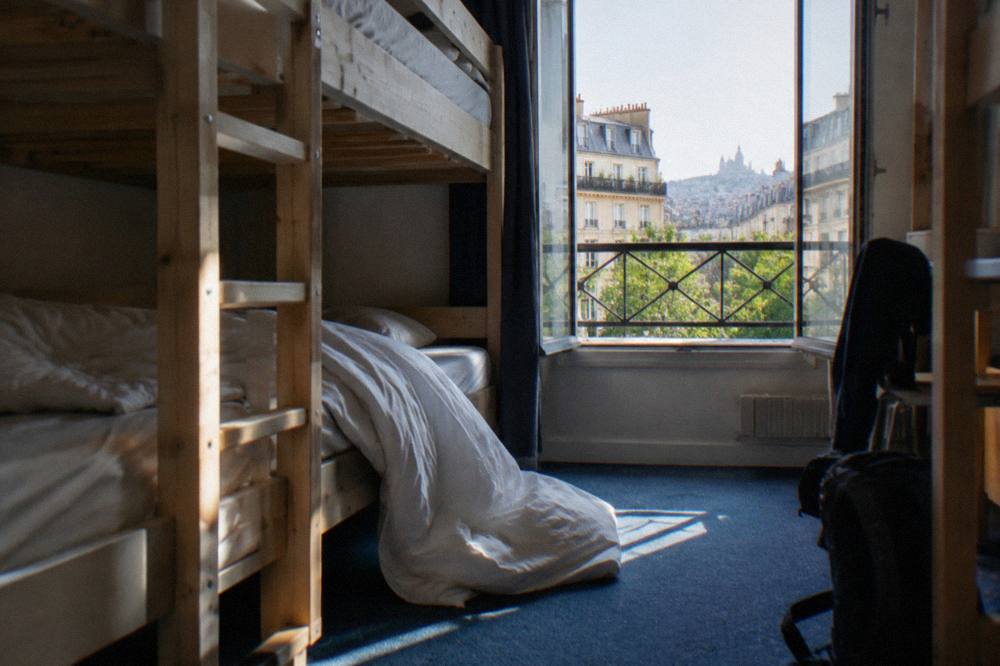 Bunk beds in a bright hostel dorm room