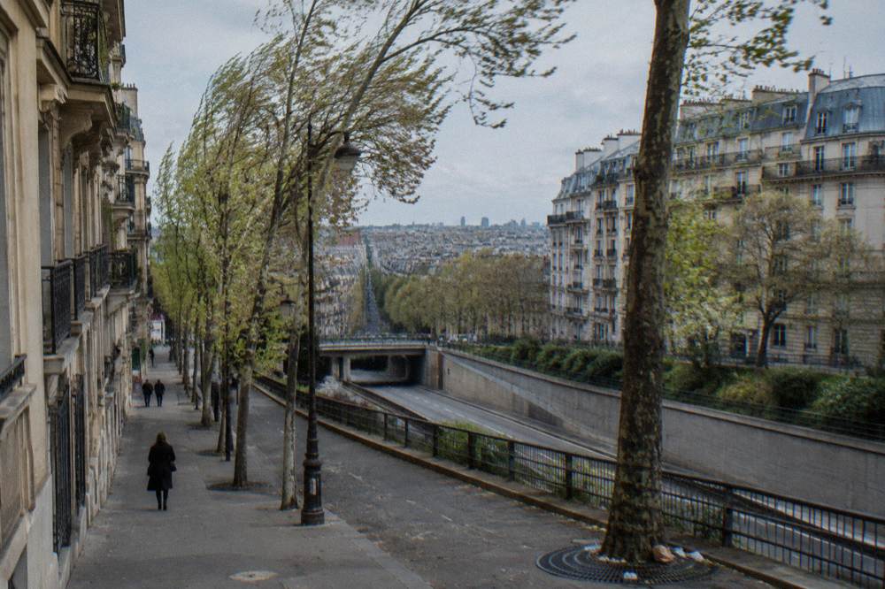 A wide boulevard at the edge of Paris with the ring road and residential blocks